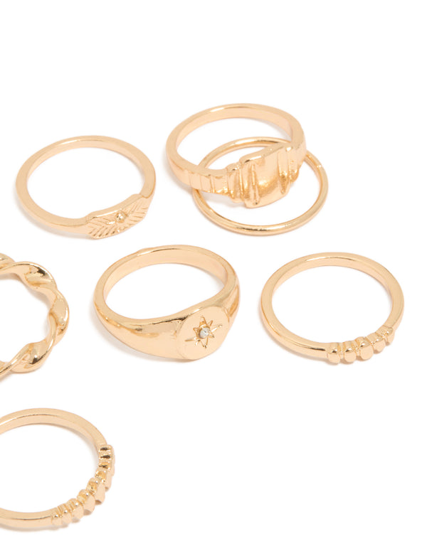 Designed with a ten-pack of gold signet and ribbed statement rings featuring celestial star details side detail view
