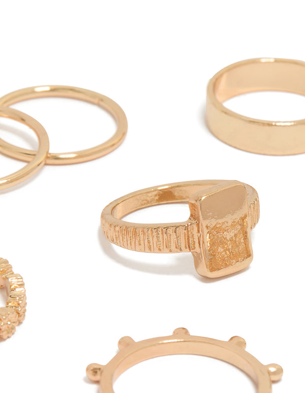 Highlighting gold mixed textured signet rings 10-pack with beaded detailing, oval and chunky design close up view
