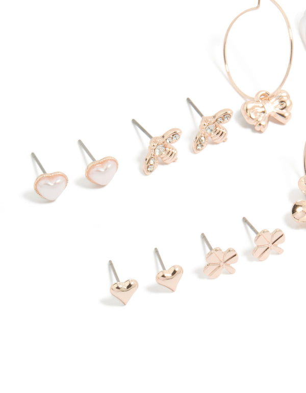 Explore rose gold pearlised flower and bee earrings 8-pack with bow, butterfly designs, heart details, ivory pearls, stud and huggie closures close up view