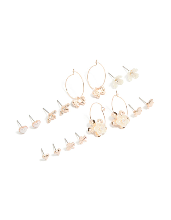 Discover rose gold pearlised flower and bee earrings 8-pack featuring motifs with bow, butterfly and pearl accents in ivory tones, stud and huggie closures front view
