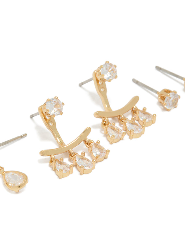 Highlighting dainty stud earrings in a 3-pack with pear cut cubic zirconia and gold plated ear jacket closures close up view