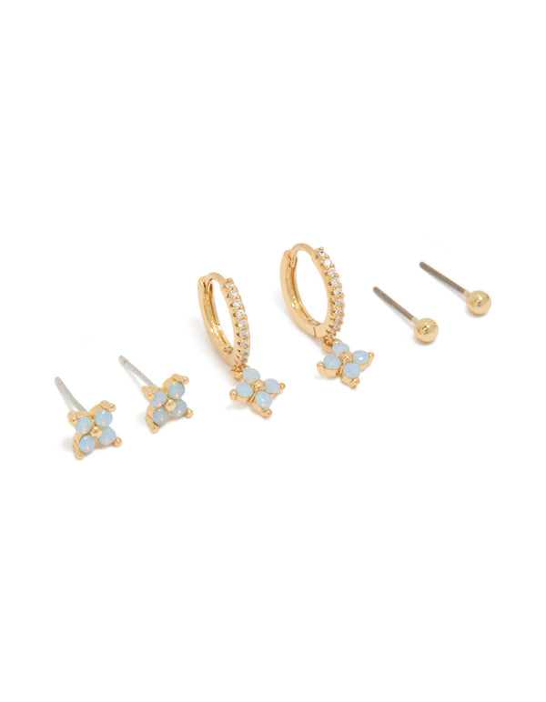 Showcasing gold plated blue flower stud and huggie earrings in a 3-pack in powder blue accents front view