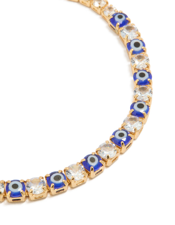 Detailed view of gold plated brass evil eye and cubic zirconia tennis bracelet highlighting intricate design close up view