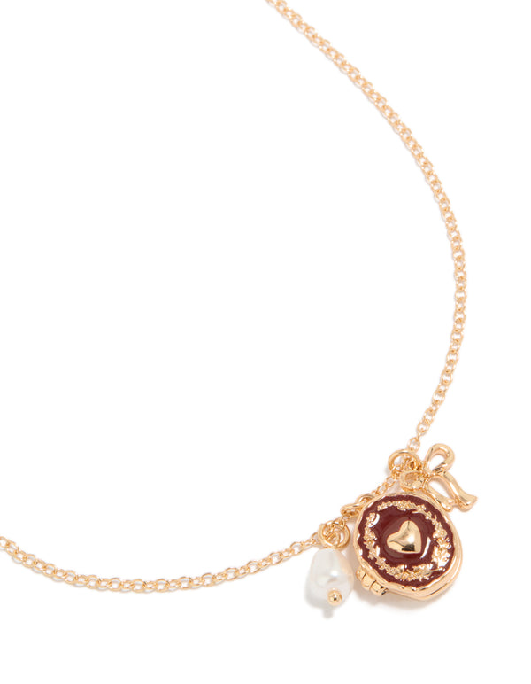 Showcasing a gold bow charm heart locket necklace with pearl pendant close up view