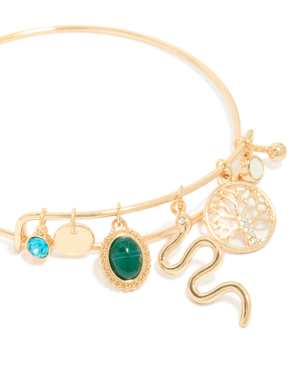 Crafted with gold snake and tree of life charm bangle featuring opal accents close up view