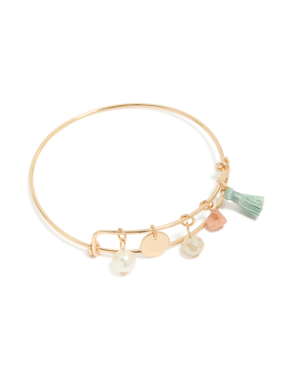 Showcasing a gold pearl, tassel, charm bangle featuring beads and disc in aquamarine, and pink front view