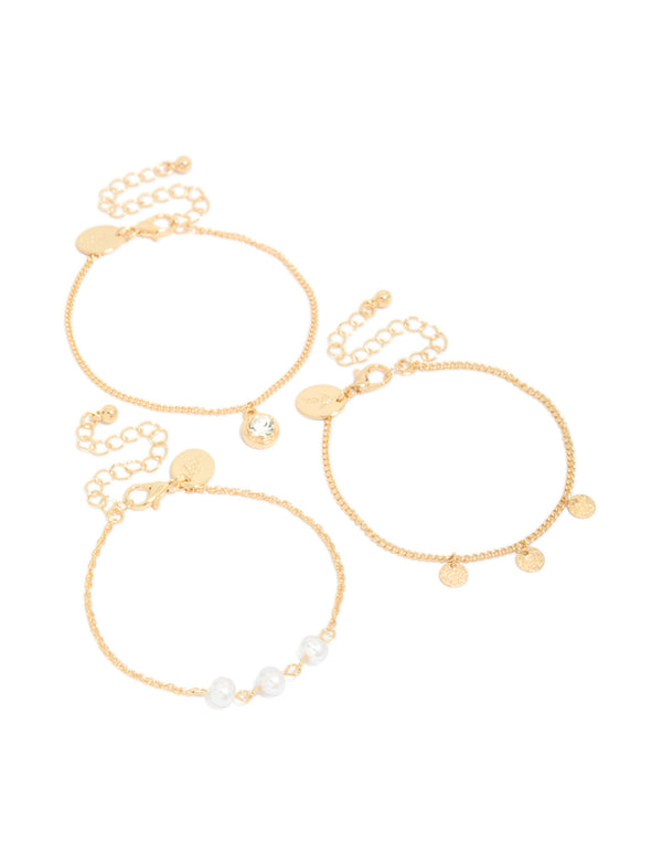 Featuring a 3-pack of gold charm bracelets accented with pearls, discs, and a solitaire-cut diamante front view