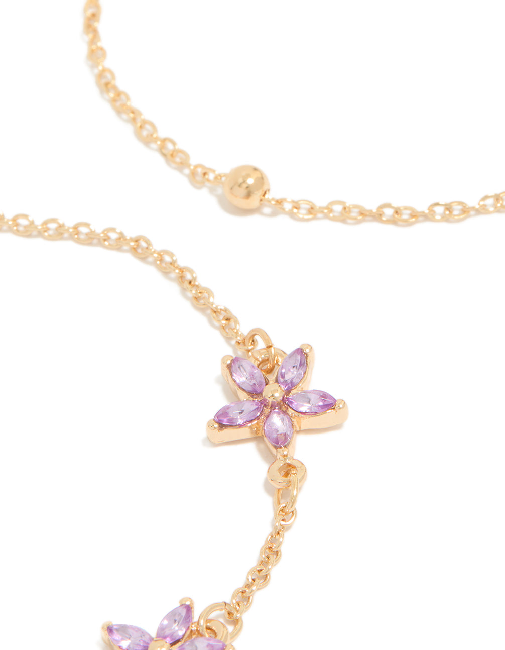 Crafted with delicate chain links featuring diamante lavender floral and gold beads close up view