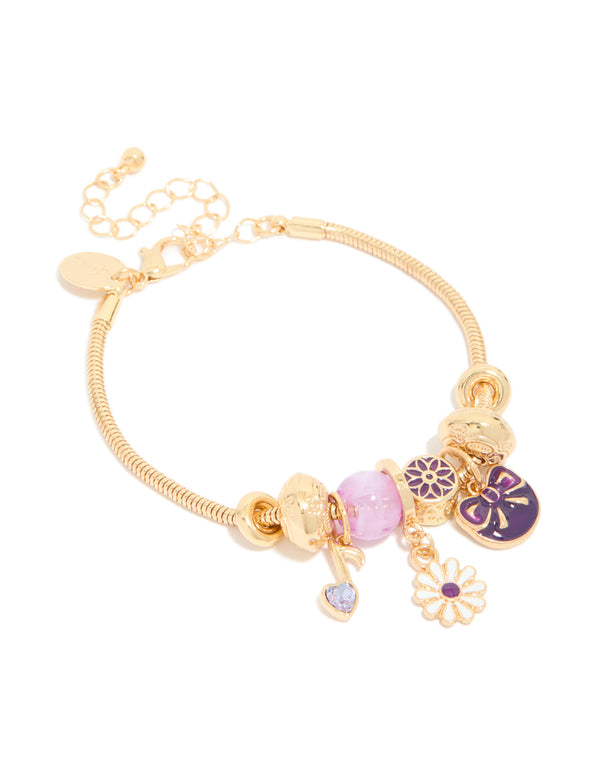 Beautifully crafted gold bow and music note charm bracelet featuring beads, floral accents, and heart details in purple, pink, and white front view