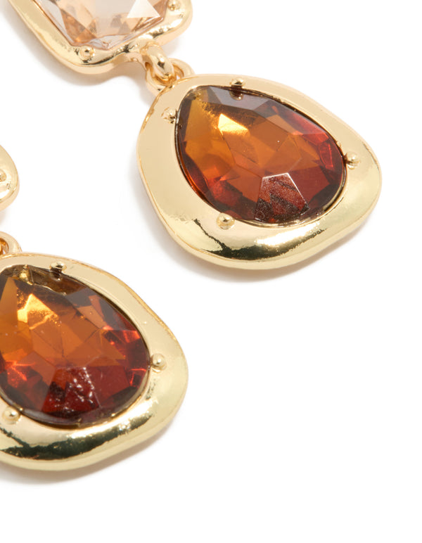 Featuring statement gold brown diamantes drop earrings with faceted stone settings close up view