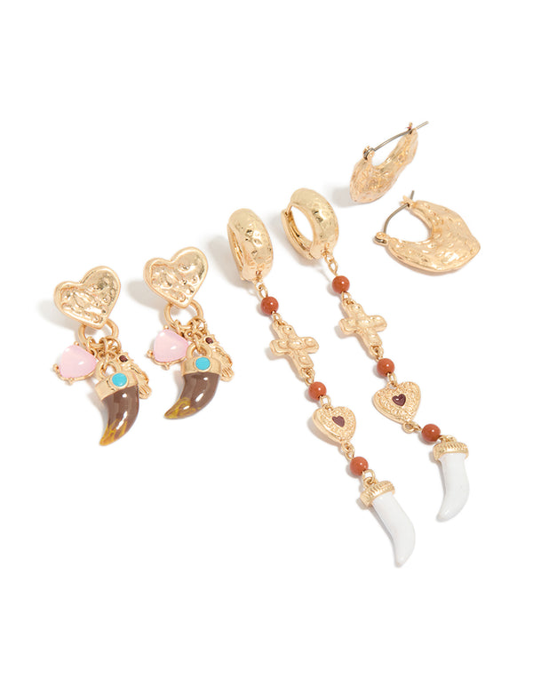 Stunning worn gold statement earrings 3-pack featuring beads, charm, cross, heart, and huggie and stud closure front view
