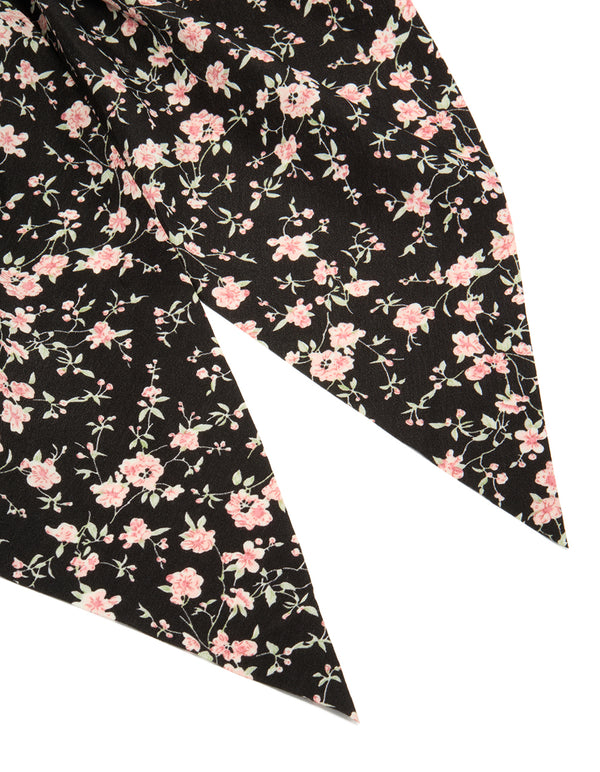 Designed with floral printed fabric in black and pink, this statement scarf scrunchie is shown in detail view