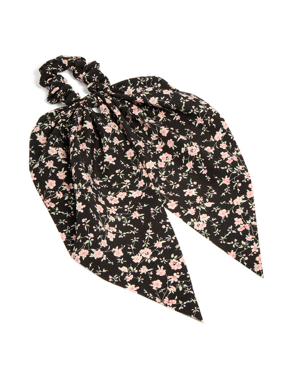 Crafted from floral printed fabric in black and pink accents, this statement scarf scrunchie is shown in front view