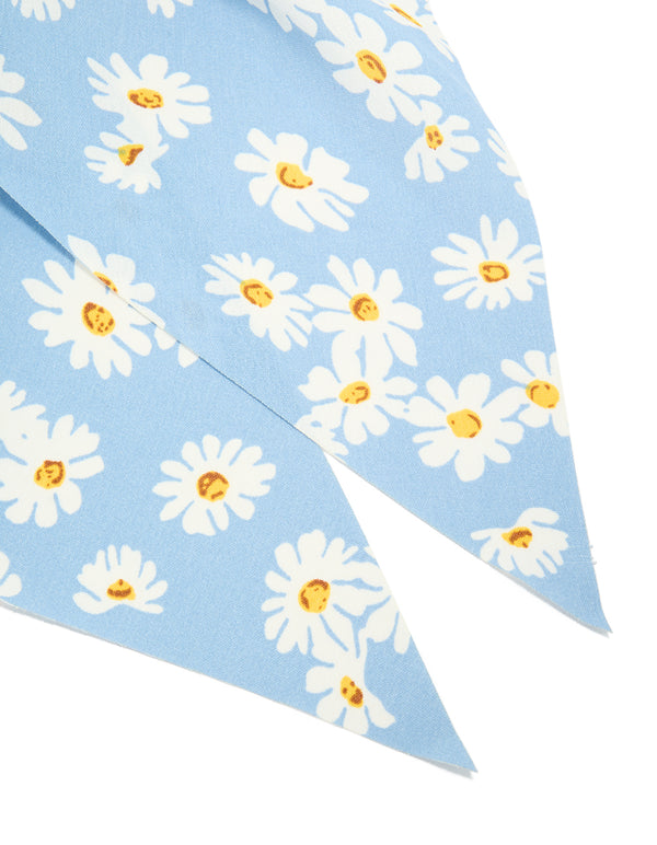 Crafted from sky blue fabric, this daisy printed scarf scrunchie features a floral print with white and yellow accents detail view