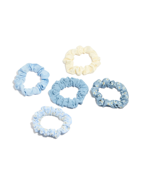 Showcase featuring daisy flower and checkered fabric scrunchies in a 5-pack with light blue, ivory, white front view
