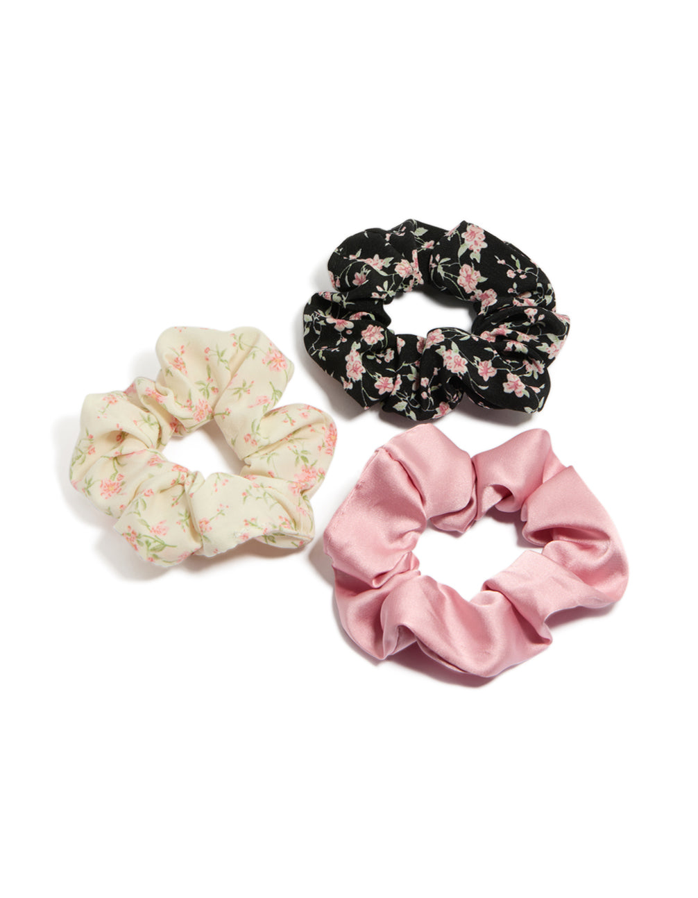 Showcasing tweens pink and cream floral scrunchies with leaf accents in a 3-pack front view
