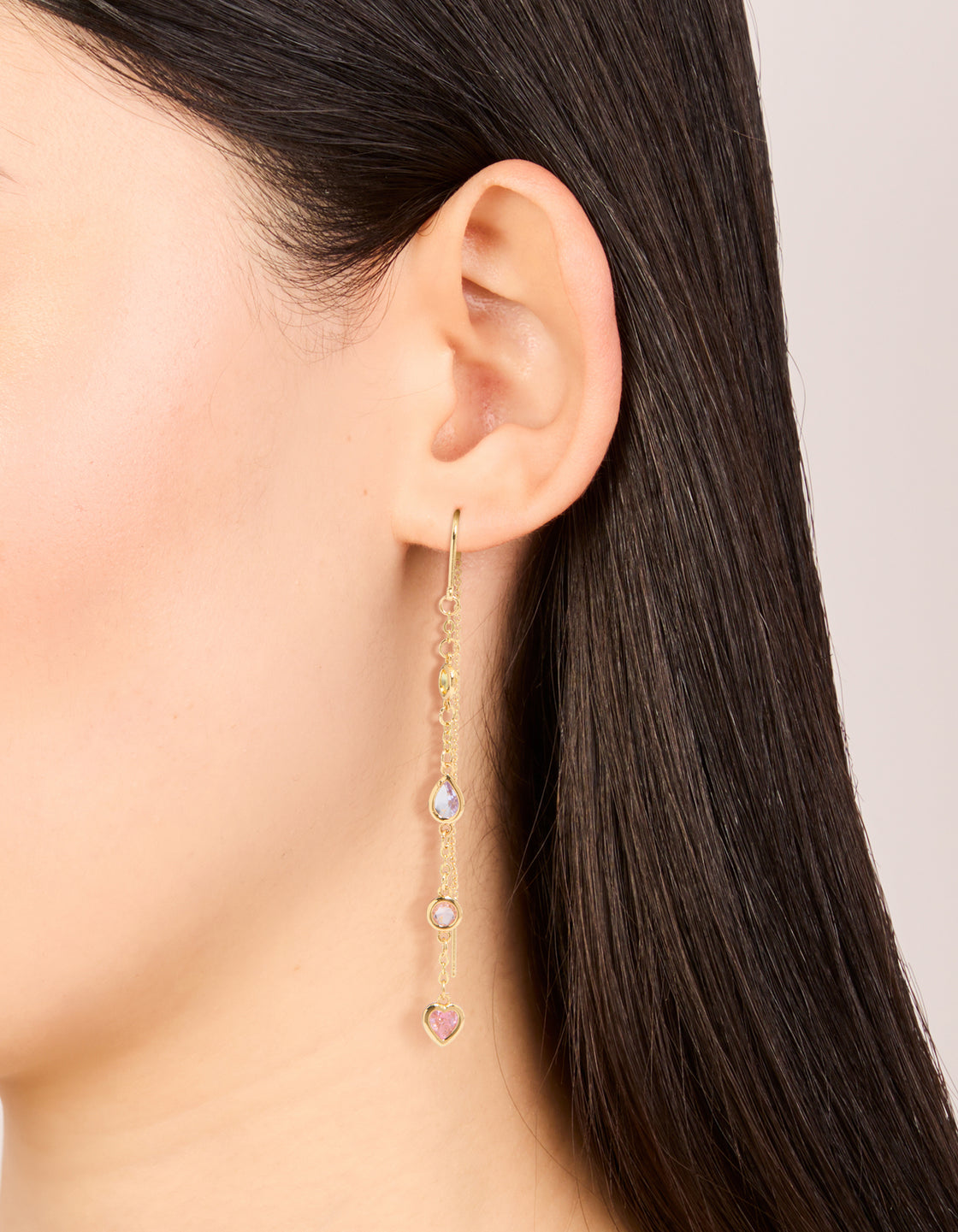 Discover gold plated heart threader earrings with pink, yellow, and purple cubic zirconia on ear view
