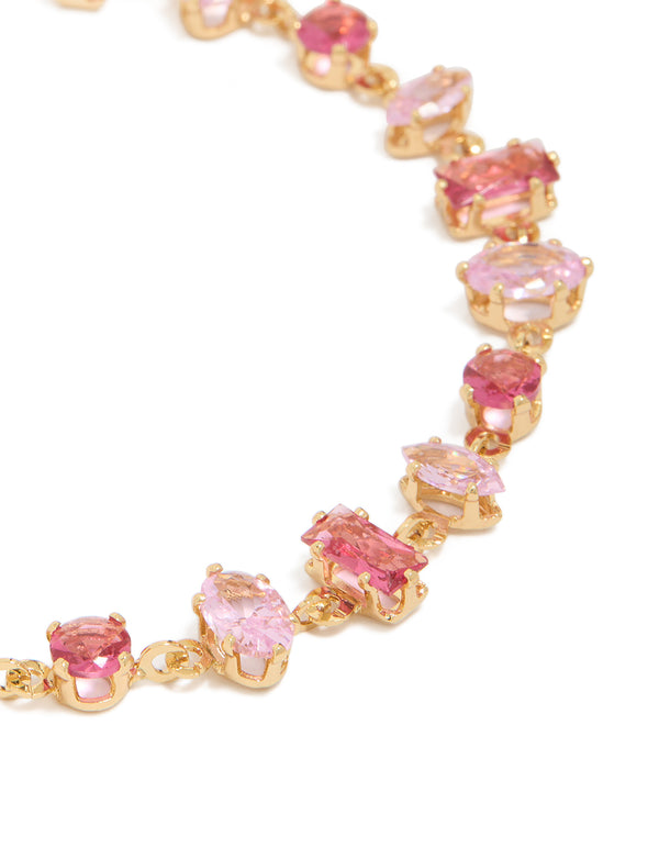 Featuring a gold large pink multi-cut cubic zirconia tennis bracelet close up view