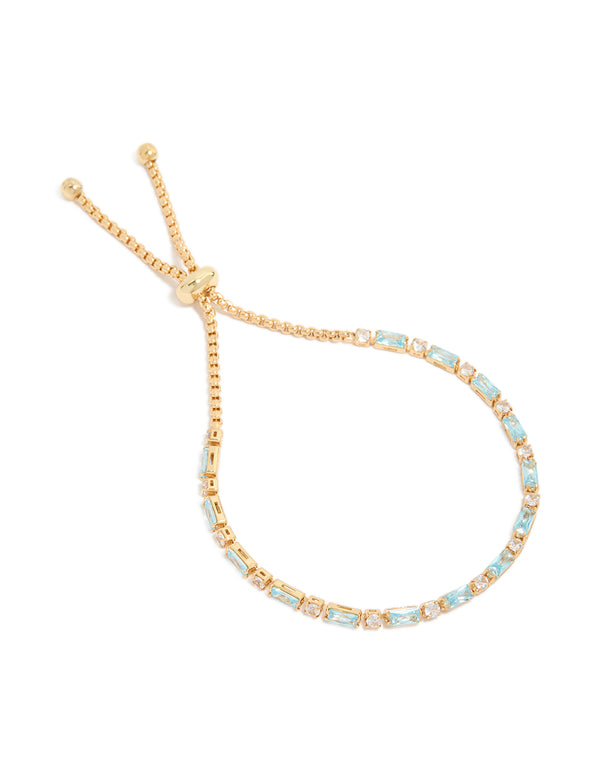 Discover this gold plated toggle bracelet featuring clear and aqua baguette cut cubic zirconia stones front view