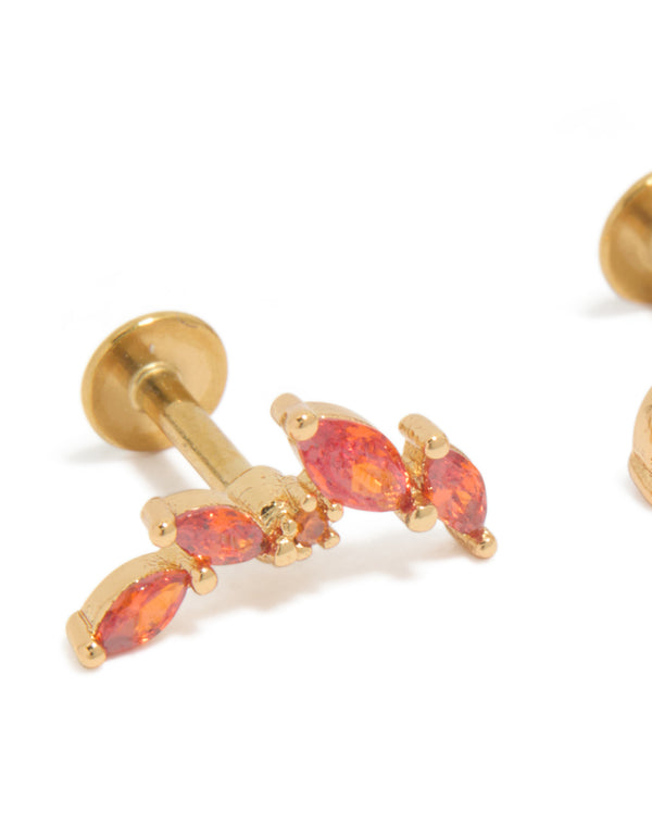 Showcasing crawler statement earrings with red cubic zirconia stones in gold plated surgical steel and flat back stud closure close up view