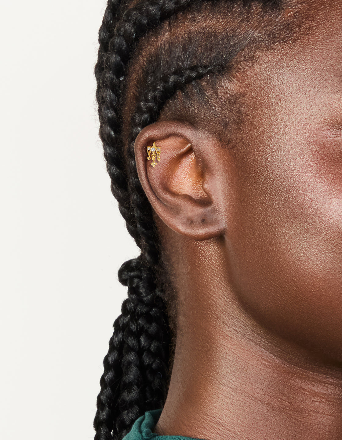 Featuring a celestial charm star flat back stud crafted from gold plated surgical steel with cubic zirconia on ear view
