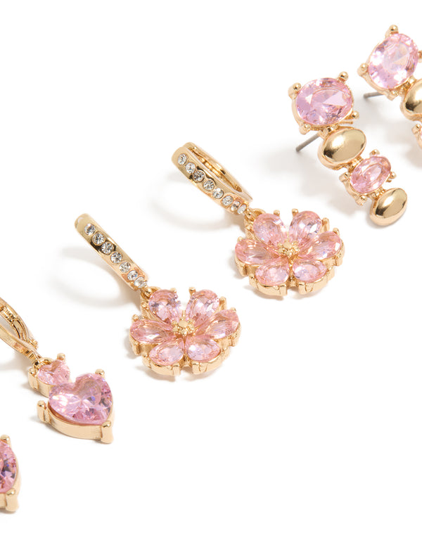 Designed with gold pink diamante flower and heart huggie earrings 3-pack featuring floral details in oval stone cut with clear accents close up view