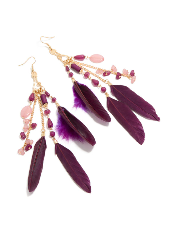 Showcasing statement drop earrings with beads, charms, and feathers in purple, gold, and pink front view