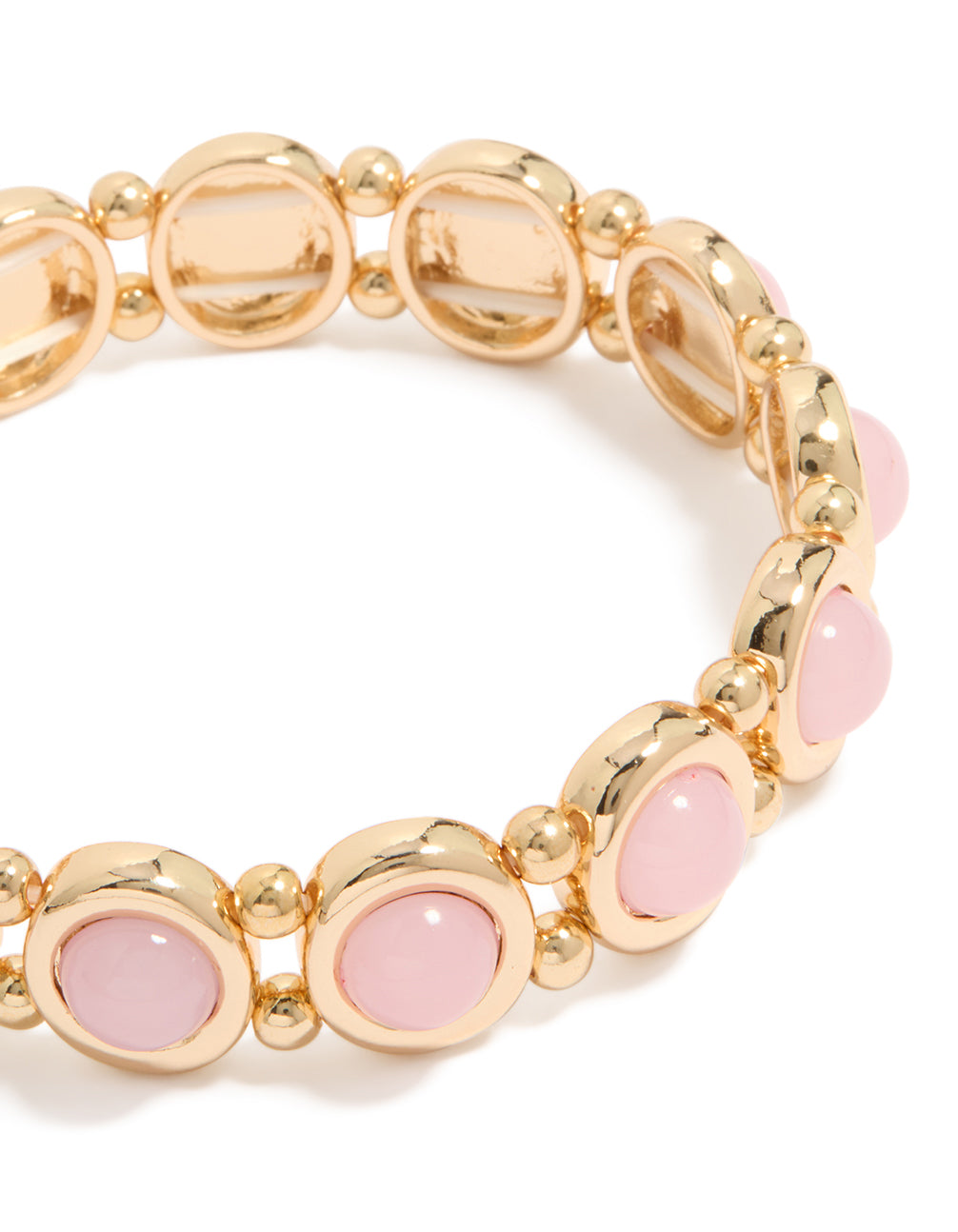 A close look at beaded organic shaped stretch bracelet in gold with pink accents close up view