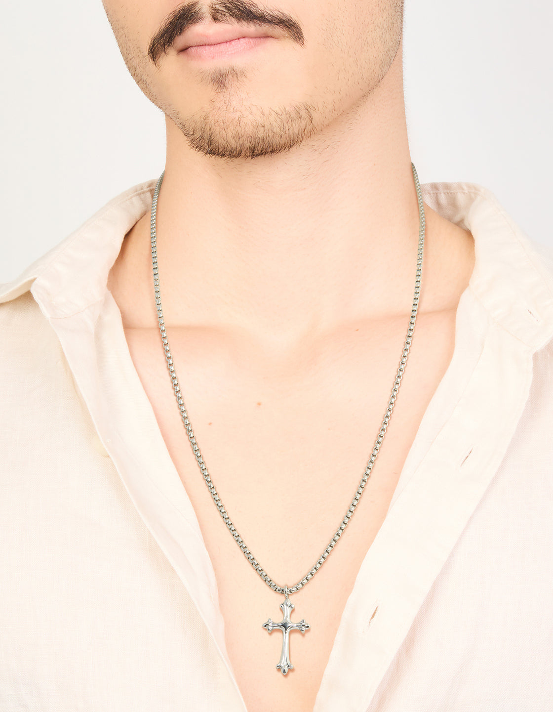 This mens waterproof stainless steel gothic cross pendant necklace in silver on neck view