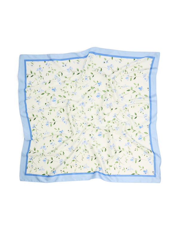Showcasing a white fabric scarf with blue floral print and leaf details in sky blue light green and forest green colors front view