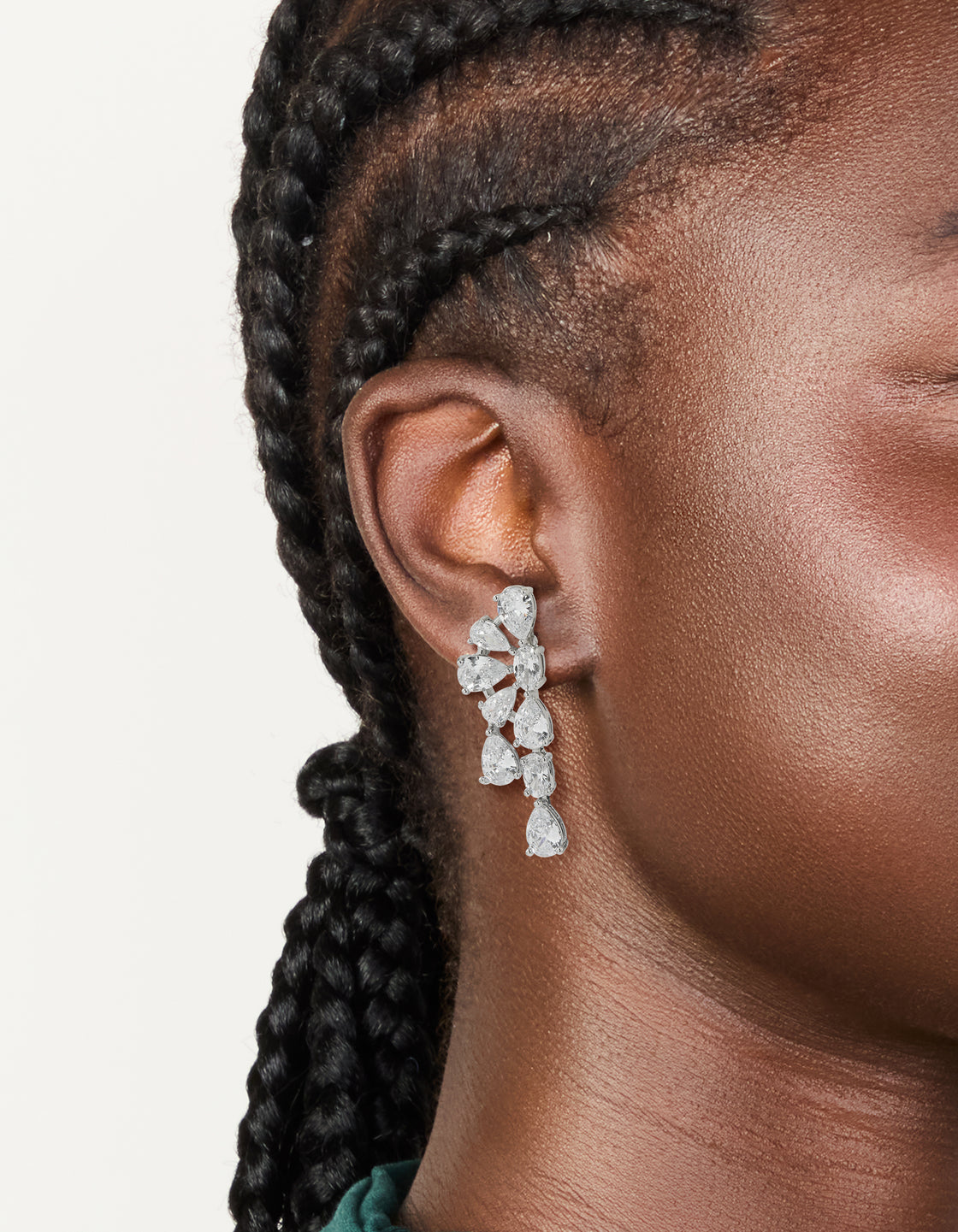 Elegant statement drop earrings with floral design featuring pear cut cubic zirconia stones in silver on ear view