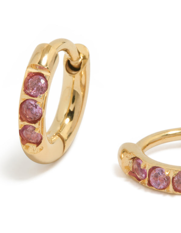 Detailed view of waterproof gold plated stainless steel pink cubic zirconia huggie earrings close up view