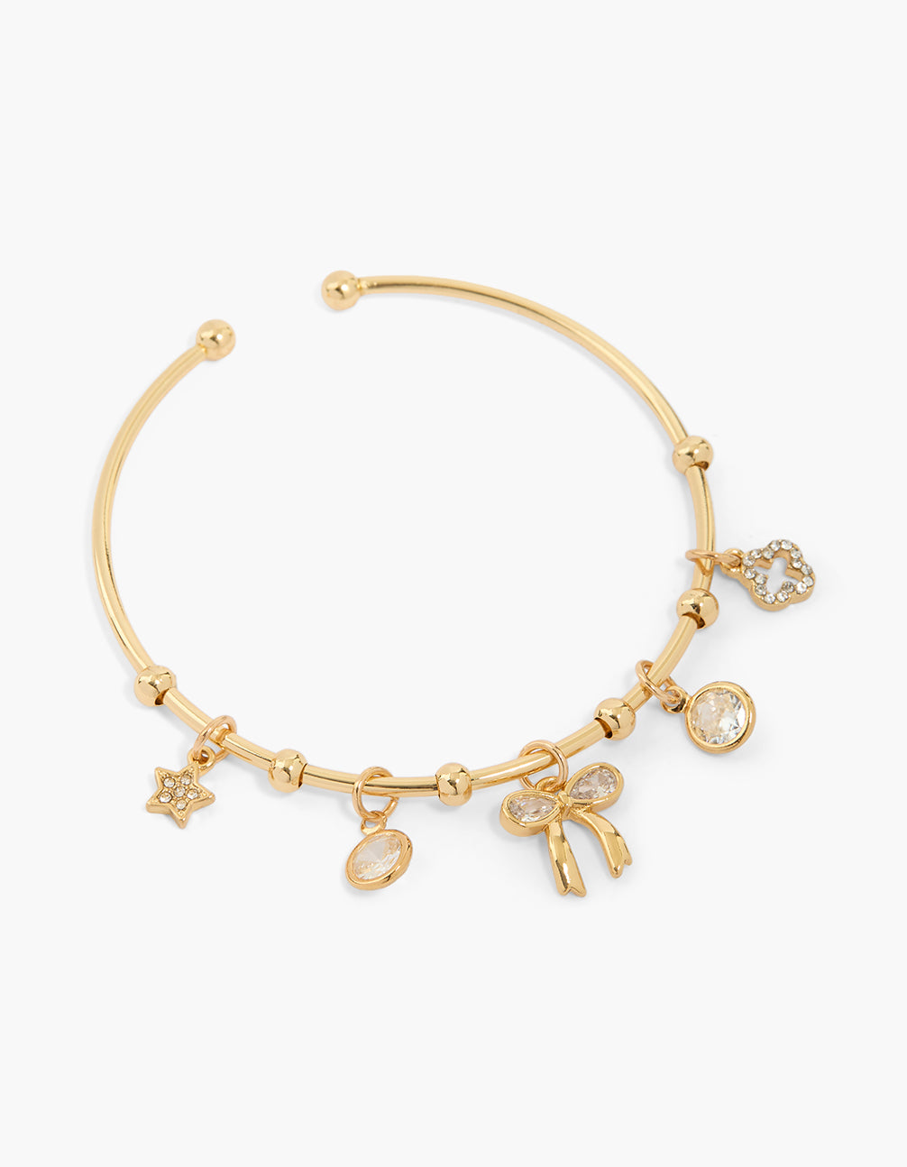 Showcasing a gold plated wrist cuff featuring bow, floral and star charm with cubic zirconia accents front view