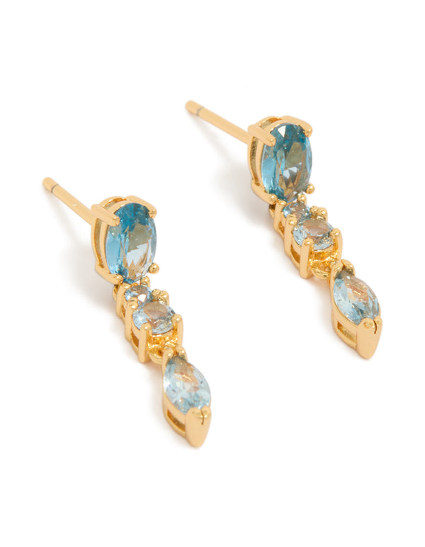 Showcasing statement gold plated light blue cubic zirconia trip drop earrings in aqua front view
