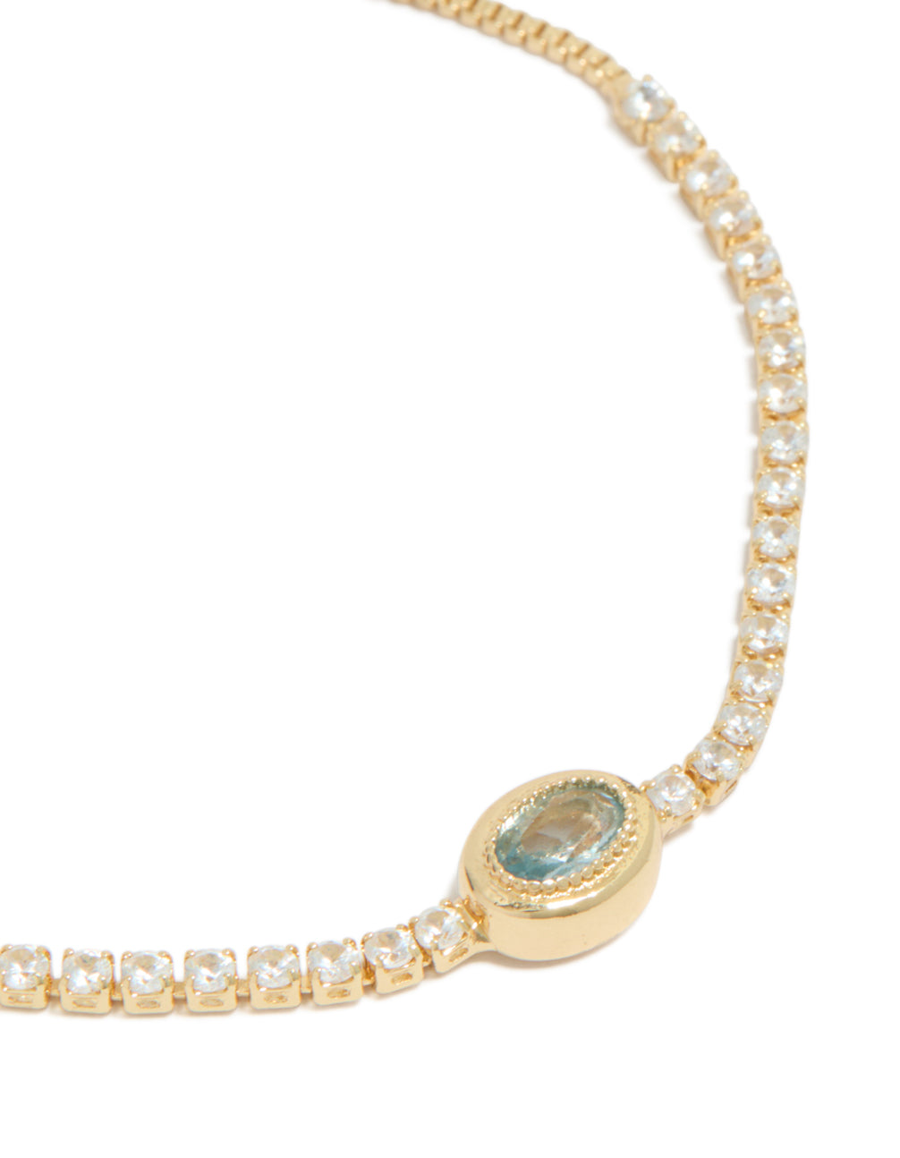 Crafted from gold plated material with cubic zirconia oval bezel toggle bracelet in teal stone in close up view