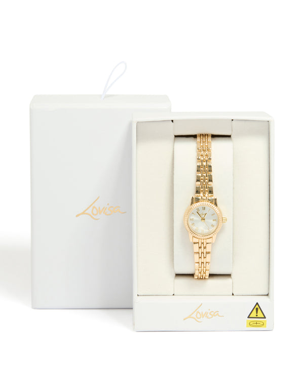 Beautifully presented gold plated mini round watch with silver dial featuring roman numerals, women's analog design, link band strap in statement formal style case detail view