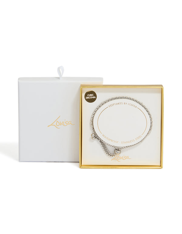 Featuring a waterproof stainless steel cubic zirconia tennis toggle bracelet in silver and clear close up view