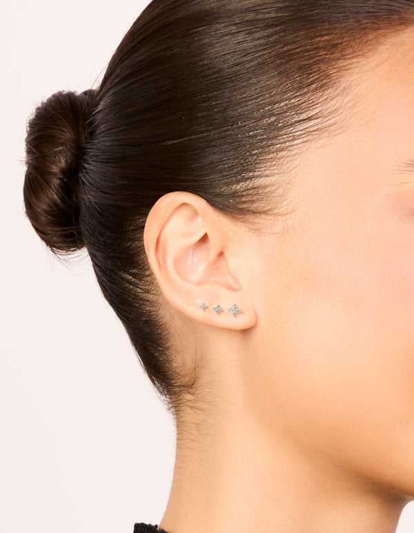 Showcasing sterling silver flower flat back stud earrings 3-pack with clear and silver on ear view