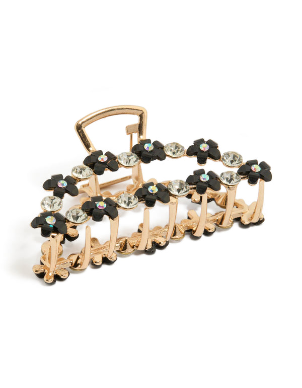 Showcasing a statement claw clip featuring floral design with mixed diamante stones crafted from resin in gold and black front view