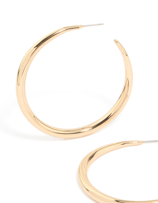 Featuring gold thin plain hoop earrings with closure in close up view
