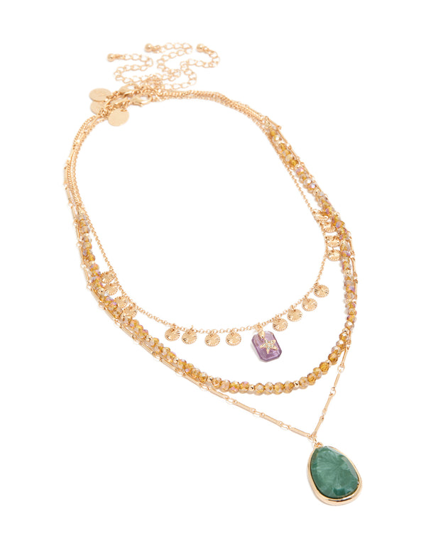 Showcasing a gold celestial star, beaded chain layered necklace with star disc charm, coin accents, pendant drops, and oval stone details in a front view