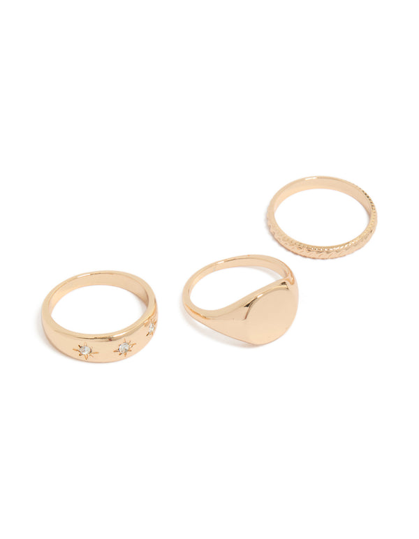 Featuring celestial star accents and signet styling in gold, this 3-pack ring set front view