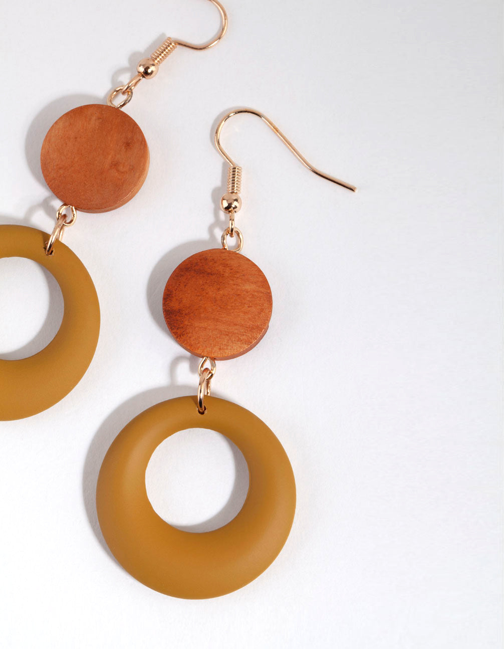 Featuring wooden matte olive drop earrings with matte finish in sienna, goldenrod, peru and gold tones close up view