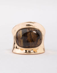 Highlighting a tortoiseshell pattern statement chunky stone band ring in gold close up view - link has visual effect only