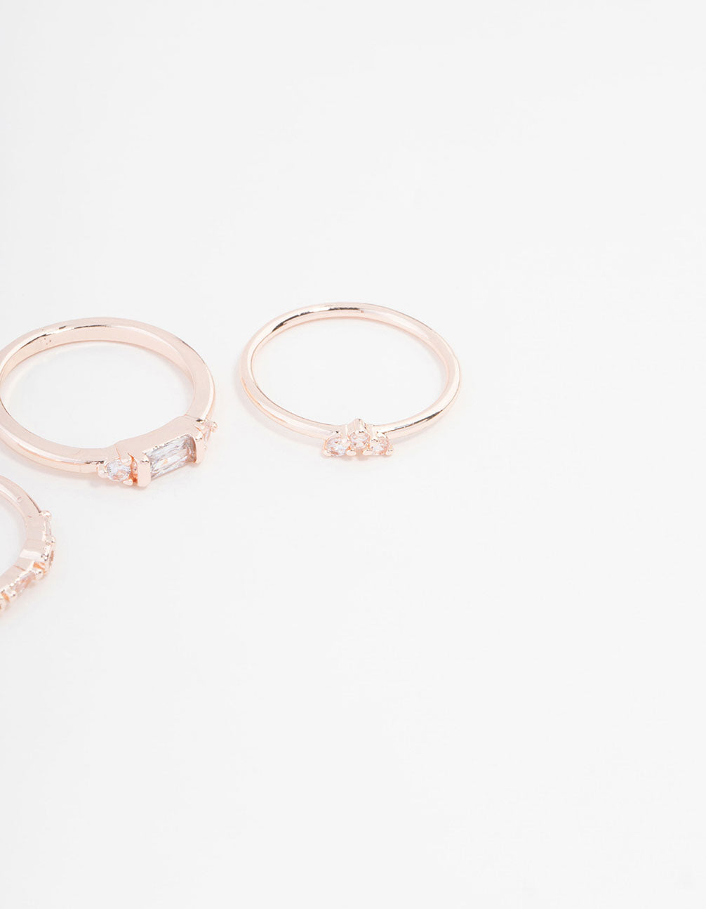 Crafted with baguette and round stone cuts, this rose gold plated cubic zirconia ring set is displayed in close up view
