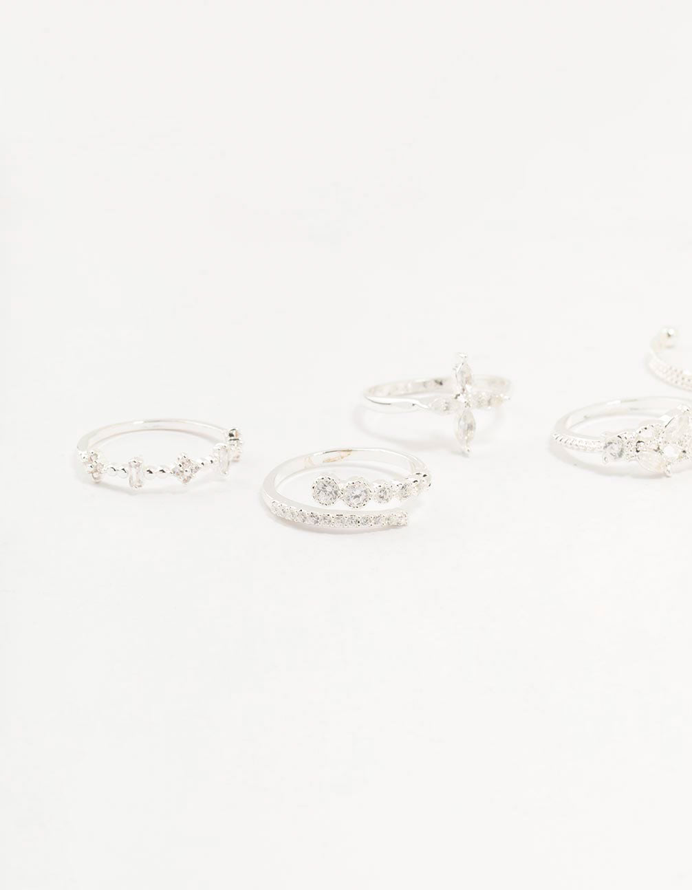 Highlighting leafy mixed rings 5-pack with floral accents crafted from cubic zirconia in gold plated metal close up view