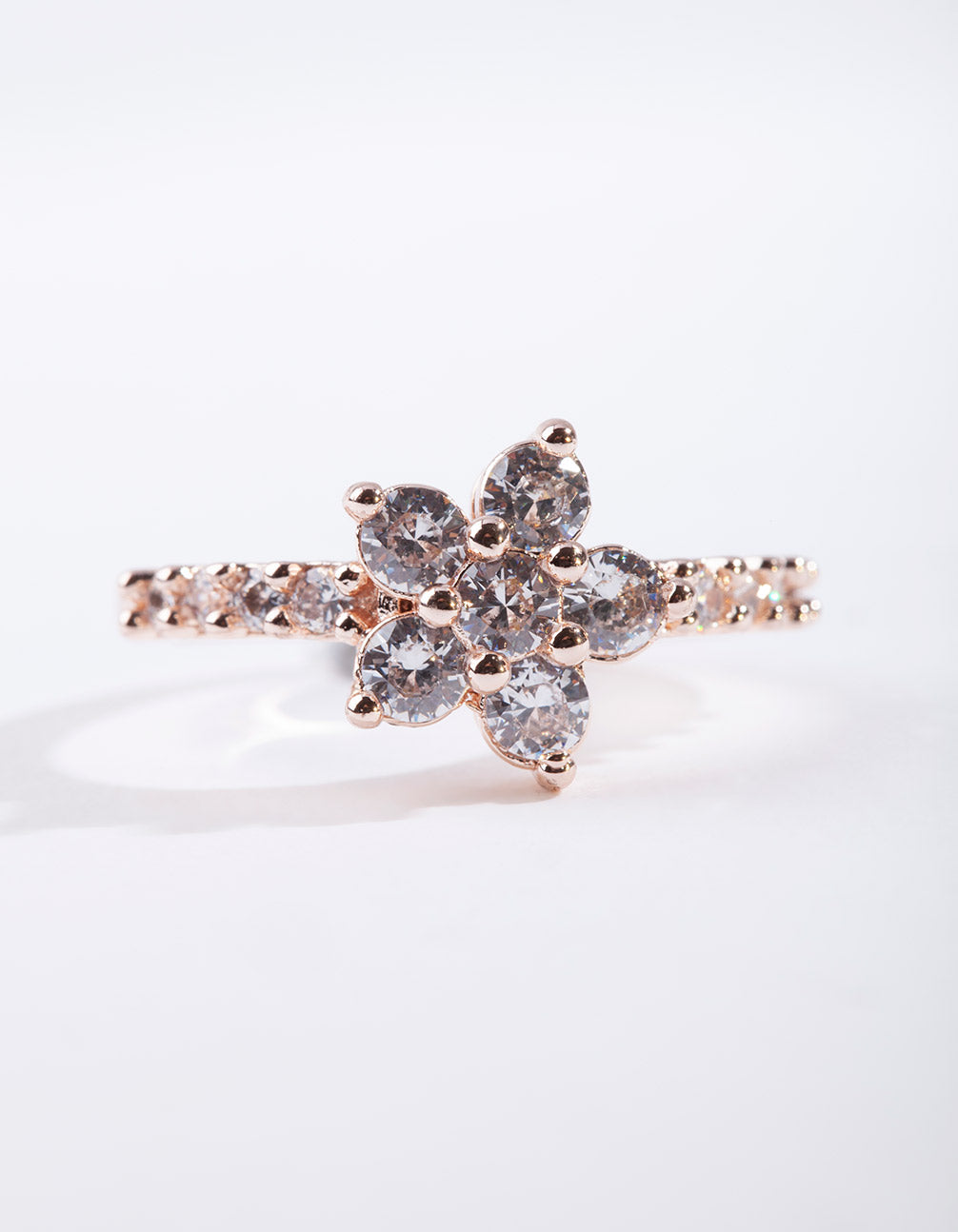 Showcasing a rose gold cubic zirconia flower ring with floral pattern and statement style front view