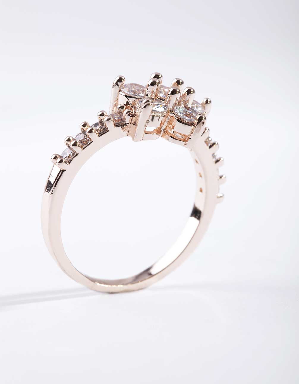 Featuring a rose gold cubic zirconia flower ring with floral pattern and statement style side detail view