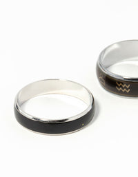 Highlighting celestial silver symbol mood ring set with black and gold detailing close up view - link has visual effect only