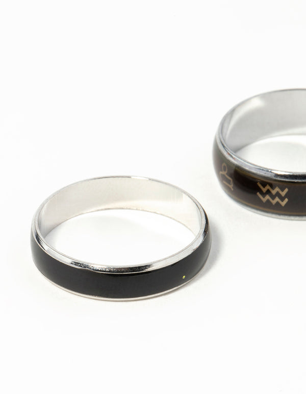 Highlighting celestial silver symbol mood ring set with black and gold detailing close up view